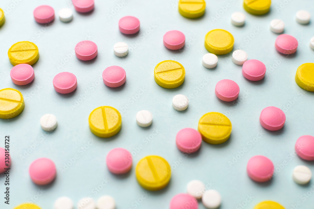 Close up colorful pharmaceutical medicine pills and tablets different medical drugs on blue background. Medicine flat lay. Close up colorful pharmaceutical medicine pills and tablets different medical drugs on blue background. Medicine flat lay.