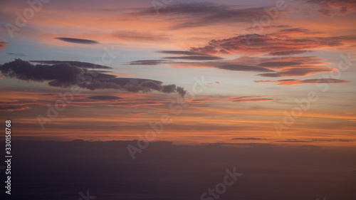 Sunset from airplane with clouds