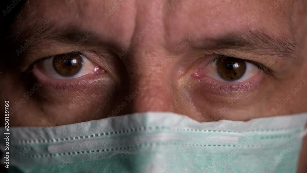 Afraid man with disposable respiratory mask Afraid man with disposable respiratory mask