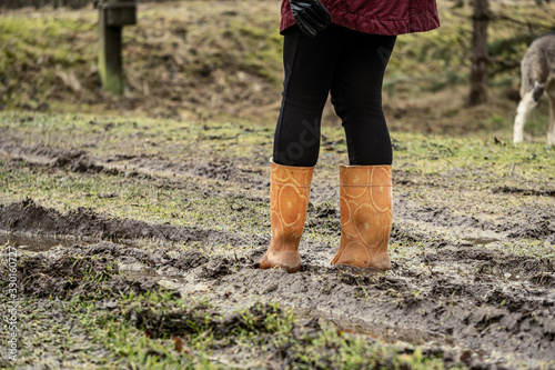 woman jumping in the puddle of mud