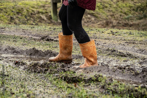 woman jumping in the puddle of mud