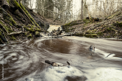 Fototapeta Naklejka Na Ścianę i Meble -  dirty waterfall on a small river in forest
