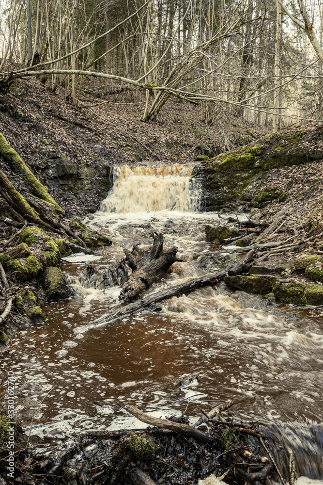 dirty waterfall on a small river in forest dirty waterfall on a small river in forest