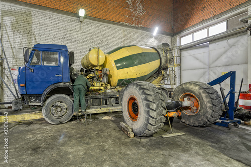 Concrete mixer machine in a repair shop.