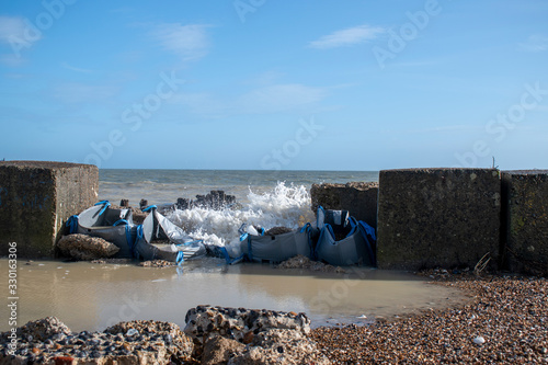 Climping Beach, West Sussex Recent storm damage caused a large gap in the sea defence where the sea floods in on each high tide.  photo