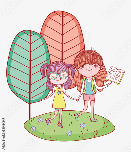 little girls holding hands with book in outdoor