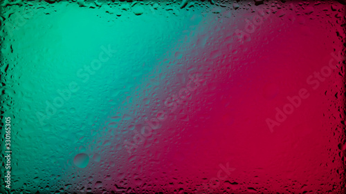 Colored abstract wallpaper on a black background with raindrops on glass