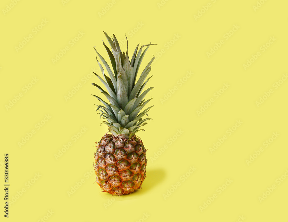 Whole Pineapple on Yellow Background.Copy space. Whole Pineapple on Yellow Background.Copy space.