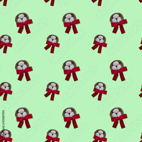 Easter seamless pattern made by nests with red bow top view