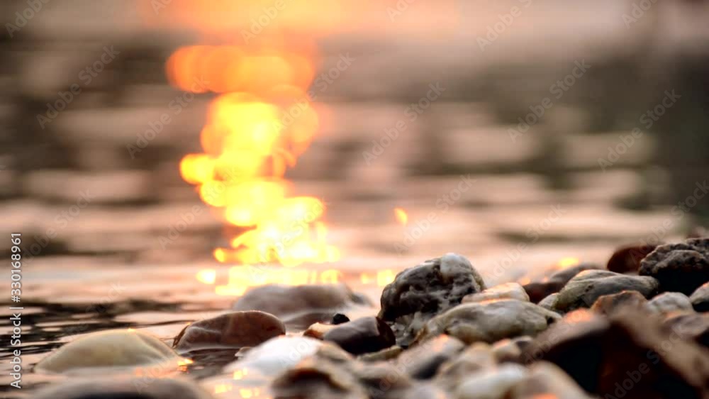video corner near the rocky edge of the river in the evening, with the sun's rays, reflected in the water and beautifully blurred. video corner near the rocky edge of the river in the evening, with the sun's rays, reflected in the water and beautifully blurred.