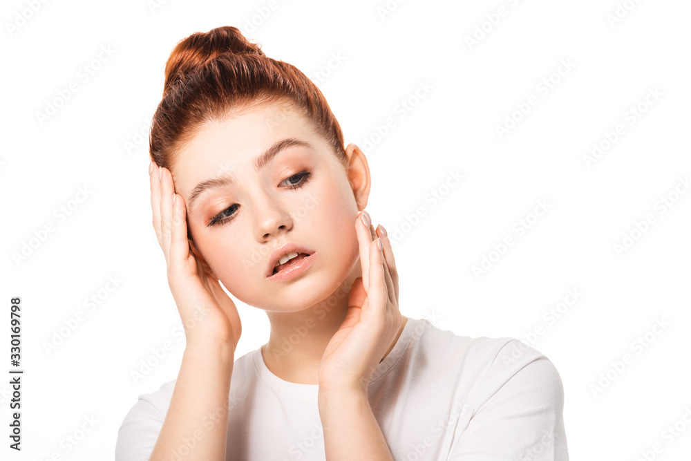 attractive female teenager with red hair touching face, isolated on white attractive female teenager with red hair touching face, isolated on white