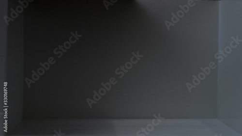 Abstract image of refraction of light and shadow in a gray room