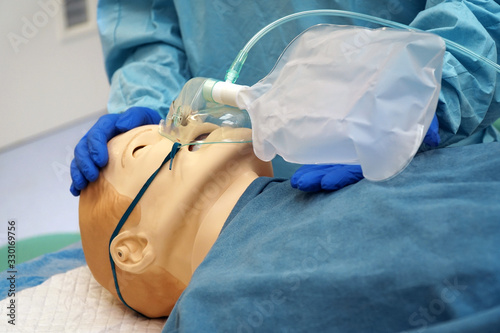 Fotografie Doctor shows the use of a non-rebreather oxygen mask using a medical patient sim