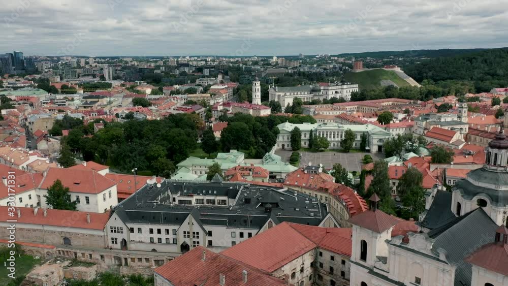 VILNIUS, LITHUANIA - JULY, 2019: Aerial view the old city with Bell tower, Presidential palace and castle mountain. VILNIUS, LITHUANIA - JULY, 2019: Aerial view the old city with Bell tower, Presidential palace and castle mountain.