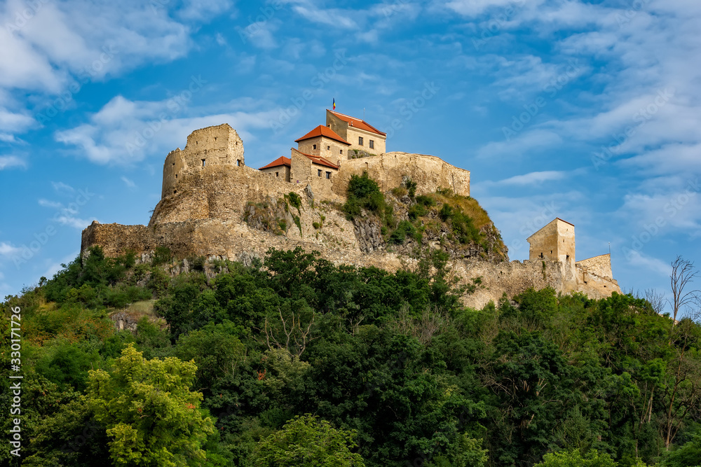 Beautiful view of the Rupea Stronghold on a blue sky with white clouds, Rupea, Brasov, Romania