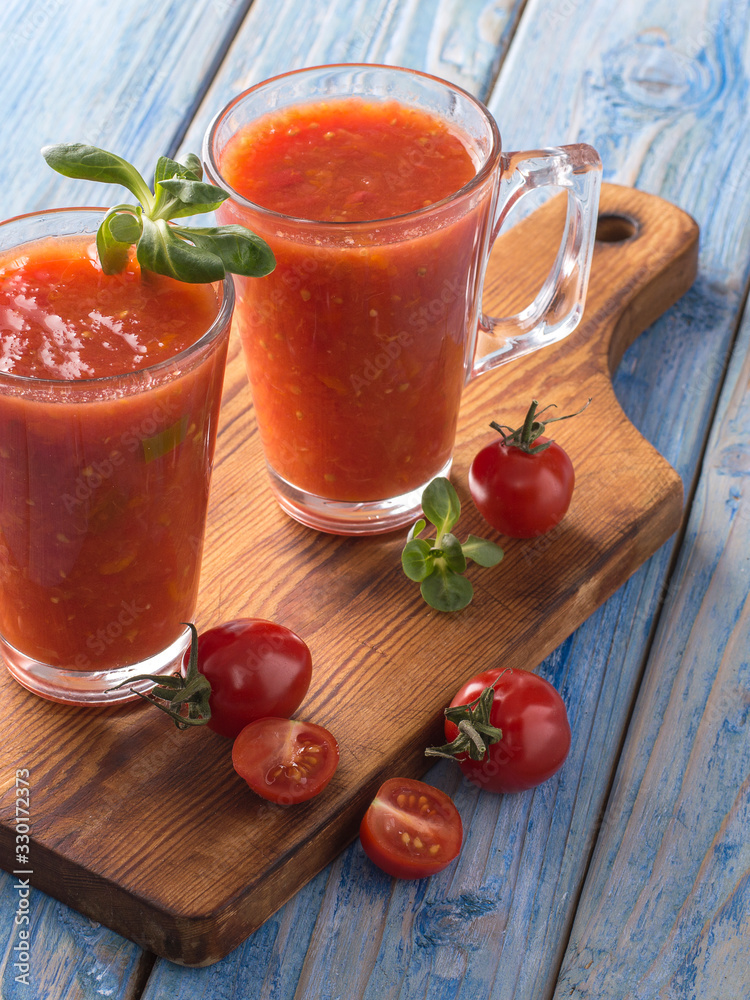 tomato juice in a glass cup on a wooden board. tomato juice in a glass cup on a wooden board.