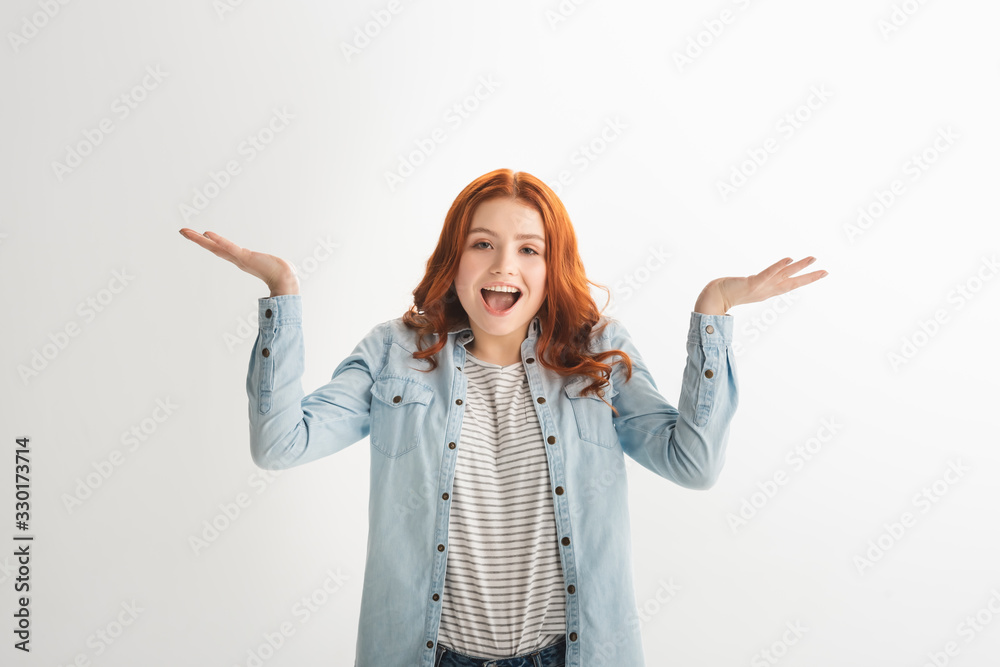 emotional redhead teen girl with shrug gesture, isolated on white emotional redhead teen girl with shrug gesture, isolated on white