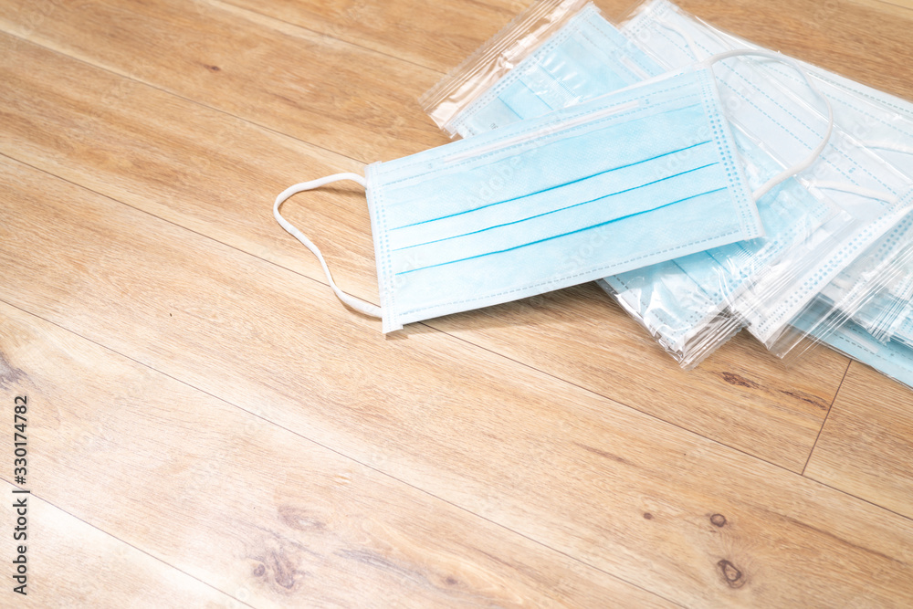 Surgical mask with rubber ear straps. Typical 3-ply surgical mask to cover the mouth and nose. Procedure mask from bacteria. Protection concept. Surgical mask with rubber ear straps. Typical 3-ply surgical mask to cover the mouth and nose. Procedure mask from bacteria. Protection concept.