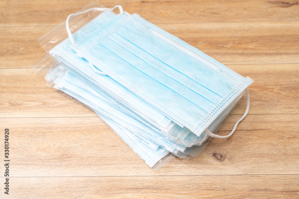 Surgical mask with rubber ear straps. Typical 3-ply surgical mask to cover the mouth and nose. Procedure mask from bacteria. Protection concept.