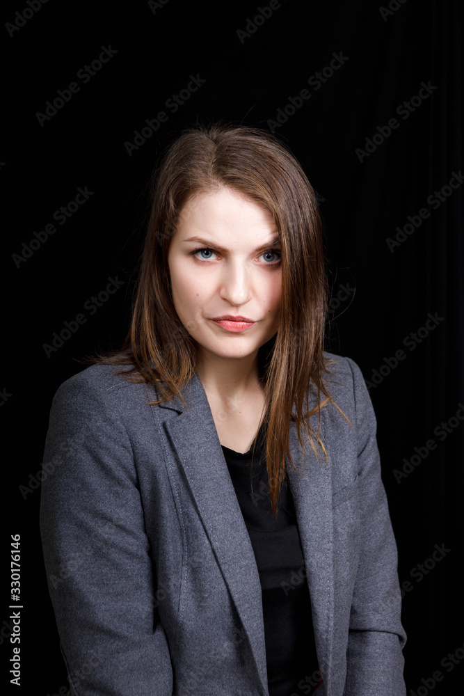 unhappy young woman in a business suit on a black backgroung unhappy young woman in a business suit on a black backgroung