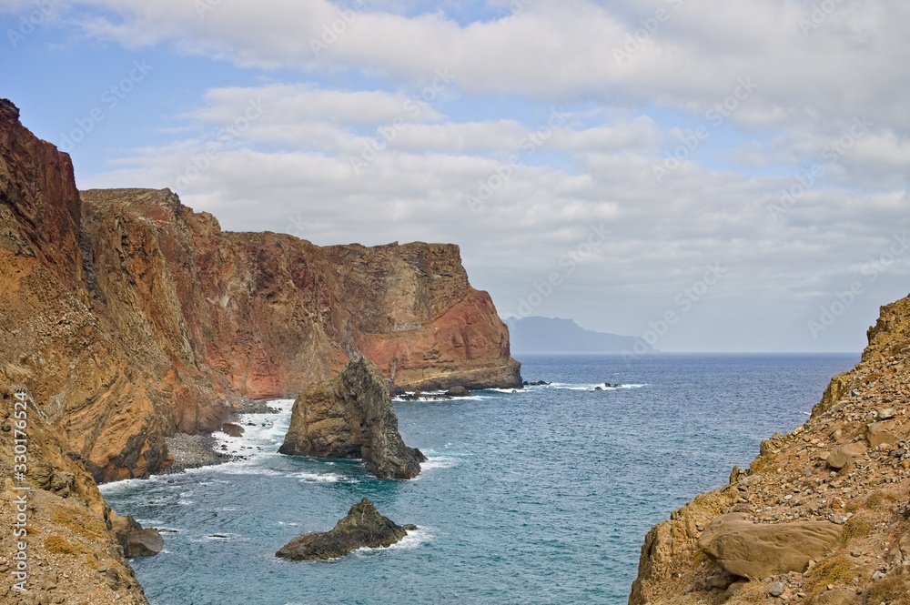 Landscape with cliffs and volcanic rock groynes in the atlantic ocean (Madeira, Portugal, Europe)