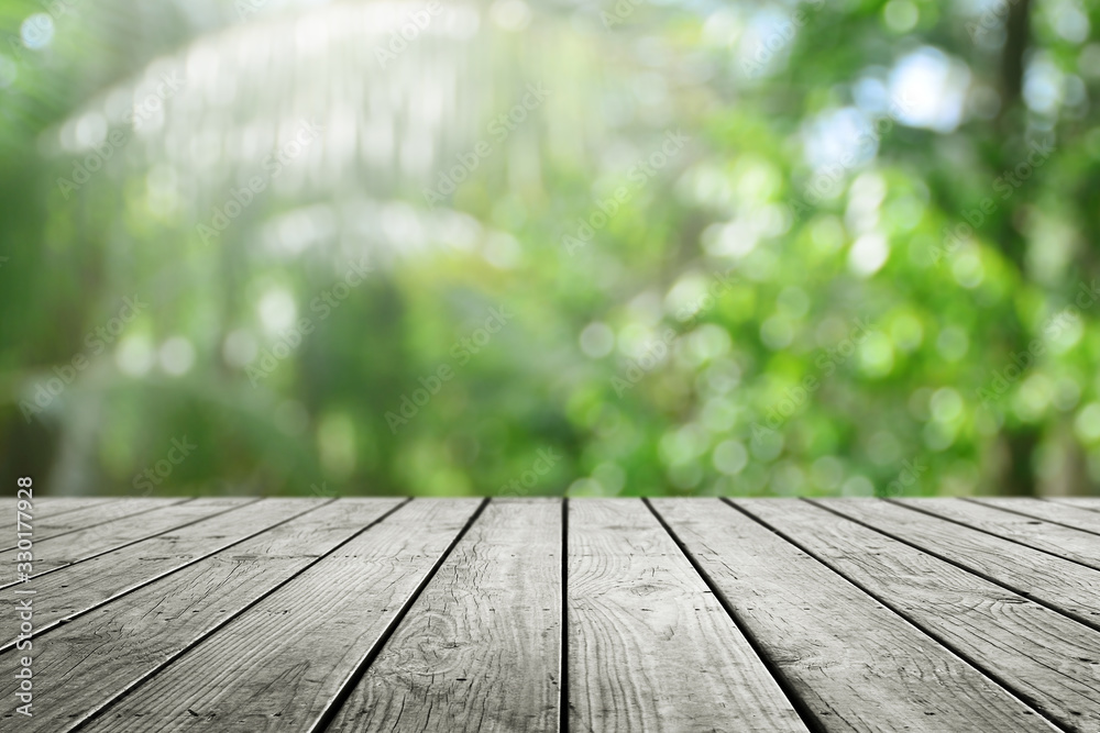 Wooden desk and blurred nature bokeh background. Wooden desk and blurred nature bokeh background.