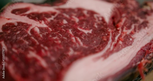 Close up view of rea juicy meat steak ready for the cook. photo