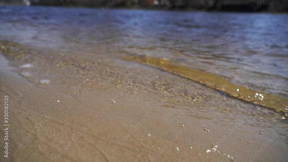 slow-motion of Crystal clear water and gold sand