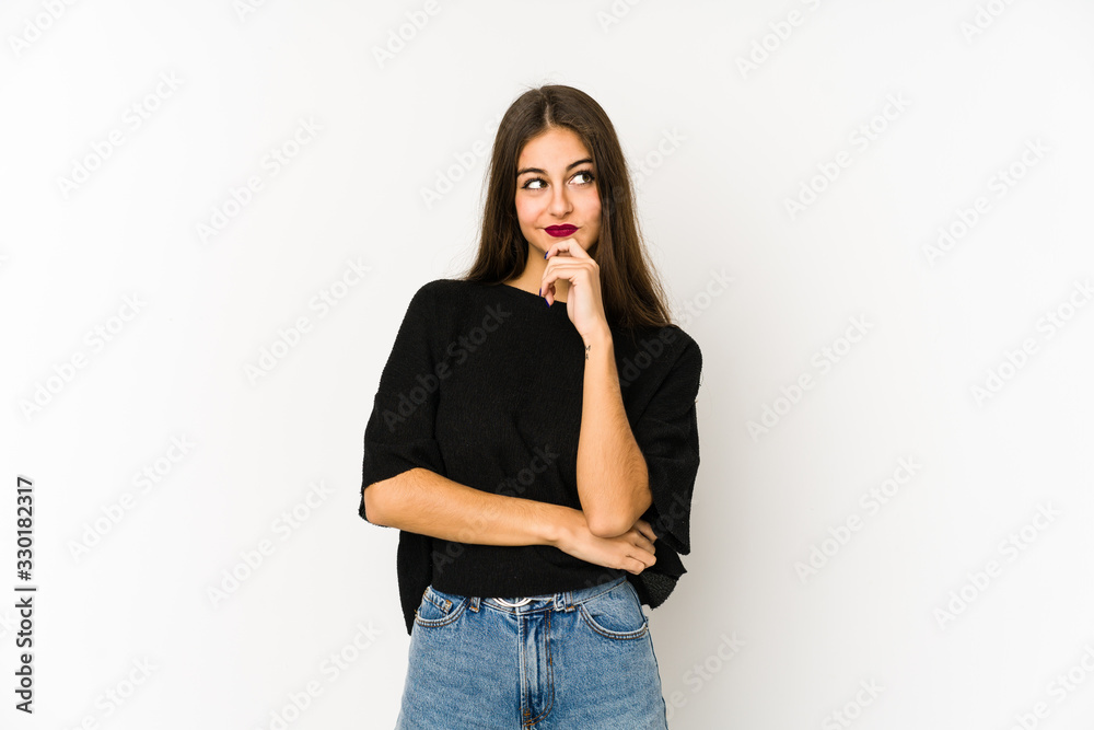 Young caucasian woman isolated on white background relaxed thinking about something looking at a copy space. Young caucasian woman isolated on white background relaxed thinking about something looking at a copy space.