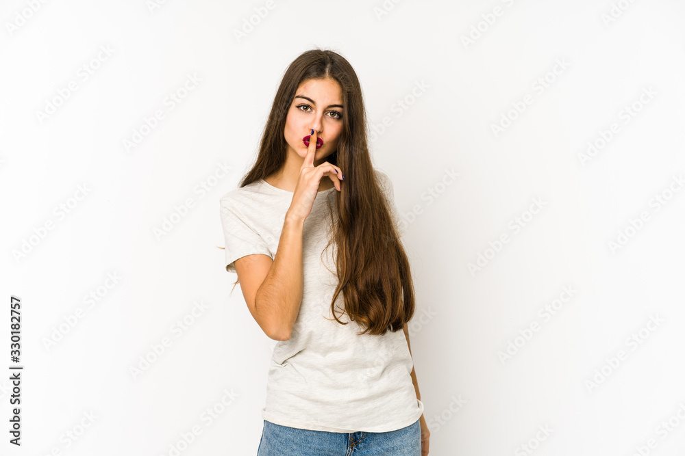 Young caucasian woman isolated on white background keeping a secret or asking for silence. Young caucasian woman isolated on white background keeping a secret or asking for silence.