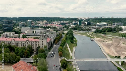 VILNIUS, LITHUANIA - JULY, 2019: Aerial top view of the pedestrianbridge over the Neris river in the quarter of Vilnius. photo