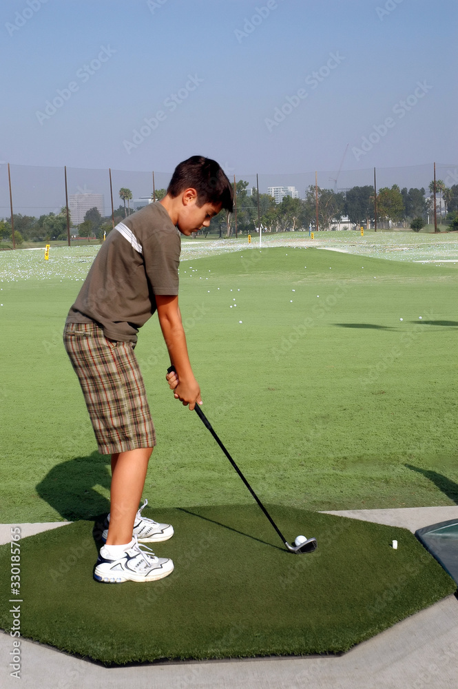 Fototapeta premium Young Golfer at Practice Range