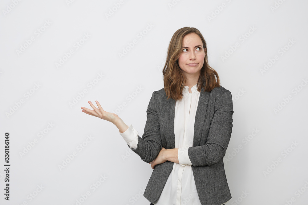 Businesswoman raising her hand not knowing what to do Businesswoman raising her hand not knowing what to do