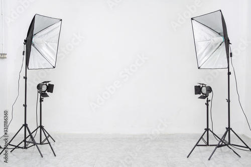 Studio lights flashes with white wall. Copy​ space​ for​ text or​ mock-up photo
