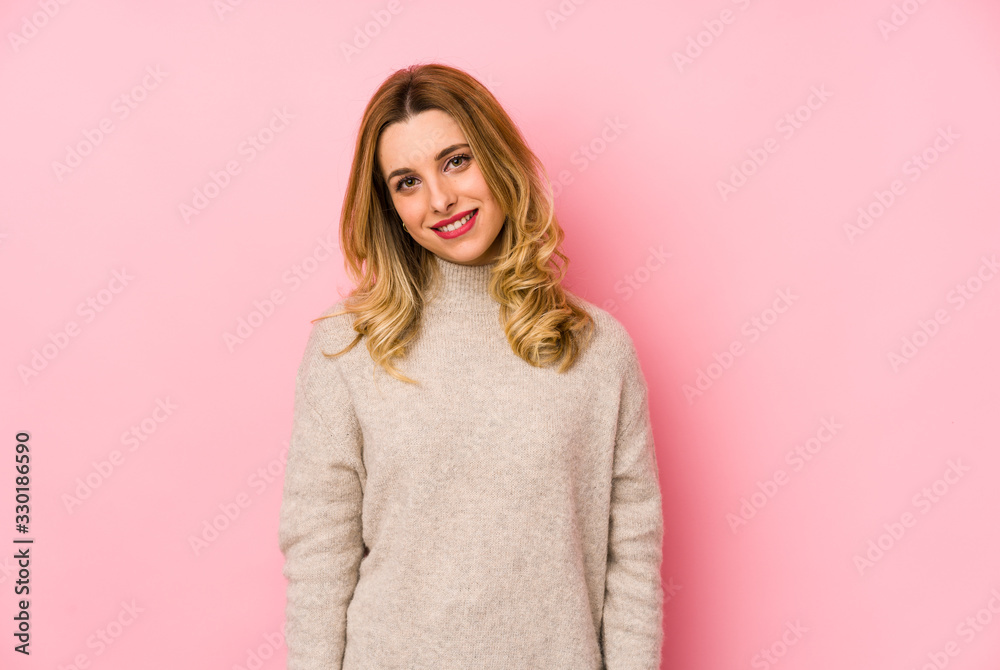Young blonde cute woman wearing a sweater isolated happy, smiling and cheerful. Young blonde cute woman wearing a sweater isolated happy, smiling and cheerful.