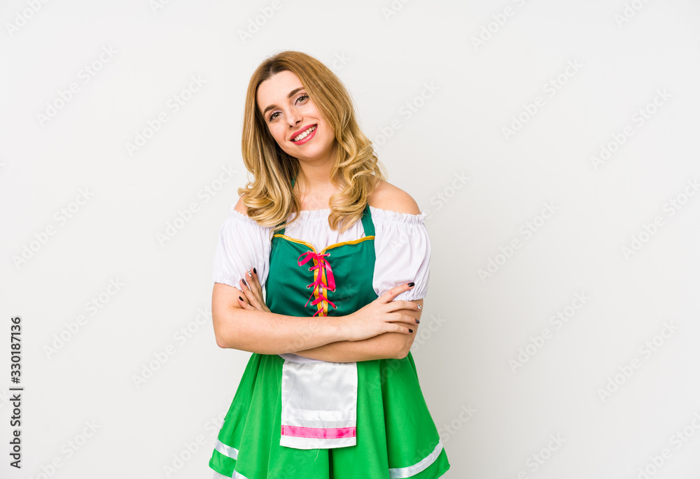 Fototapeta premium Young woman wearing a saint patricks day clothes isolated laughing and having fun.