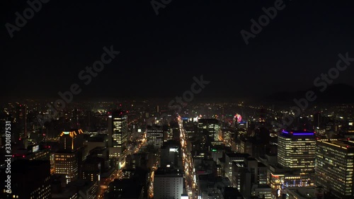 Wallpaper Mural SAPPORO, HOKKAIDO, JAPAN - FEB 2020 : Aerial high angle sunrise view of cityscape of Sapporo city. View of buildings and street traffic around Susukino downtown area. Time lapse shot night to morning. Torontodigital.ca