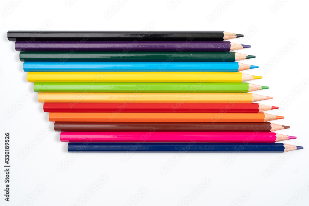 Colored pencils in a row isolated on white background. Colored pencils in a row isolated on white background.