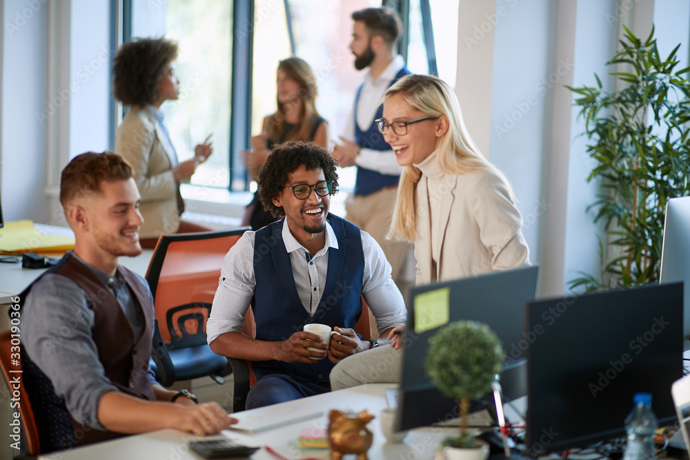 Business people having coffee break at work..Cheerful colleagues sitting and smiling at workplace together.Communication concept