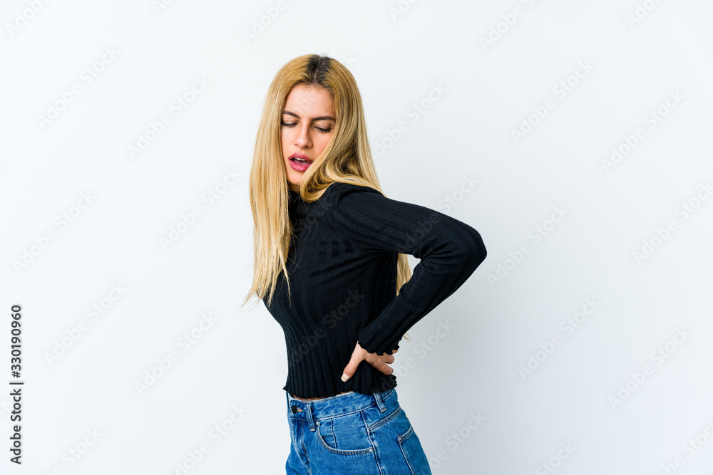 Young blonde woman isolated on white background suffering a back pain. Young blonde woman isolated on white background suffering a back pain.