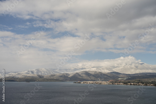view of sea and snowy mountains