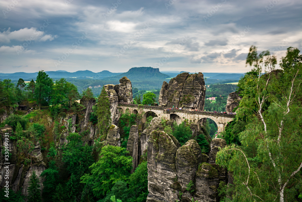Fototapeta premium Famous bridge Basteibruecke in Saxon Switzerland on a cloudy day