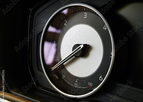 Tachometer with integrated temperature sensor. The arrow indicates zero. Interior of a modern luxury car. New modern luxury cars: sale, repair, spare parts. Concept.