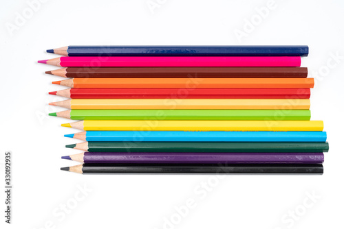 Colored pencils in a row isolated on white background.