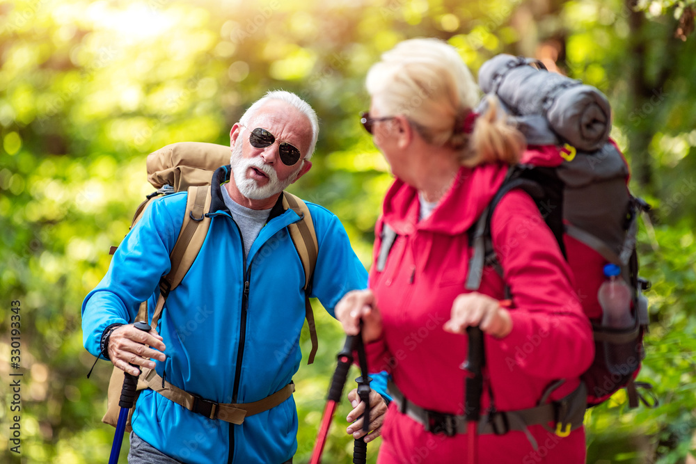 Happy senior couple of hikers in the forest. Happy senior couple of hikers in the forest.
