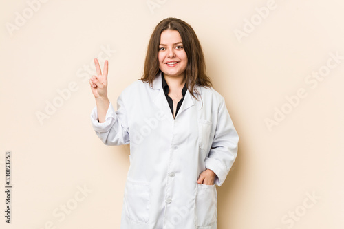 Young doctor woman showing number two with fingers.