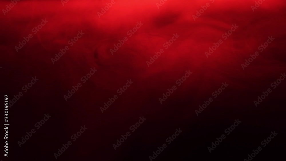 Red smoke spreads like fog. Texture of cigarette white smoke on a black background. Slow motion.
