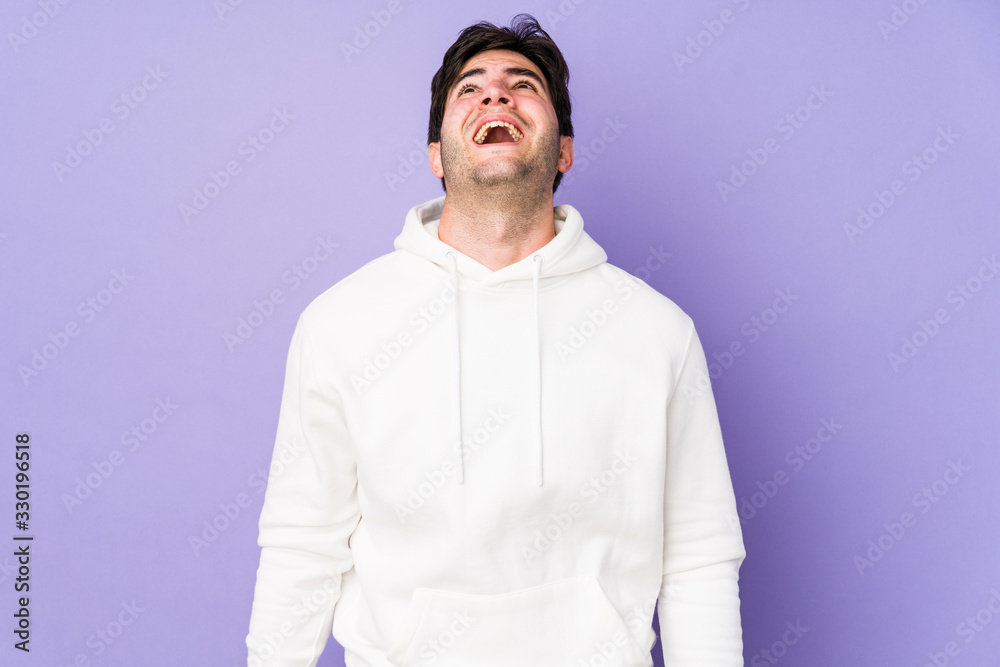Fototapeta premium Young man isolated on purple background shouting very angry, rage concept, frustrated.