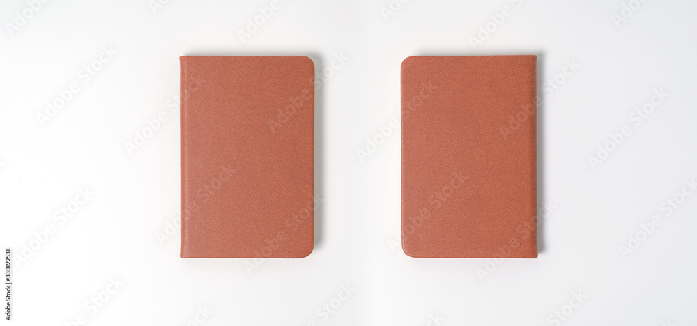 top view blank orange leather diary on white desk top view blank orange leather diary on white desk