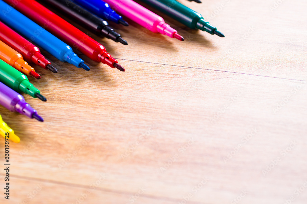 Obraz premium multicolored pencils on the wooden table background